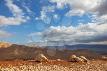 Gorgeous clear day in the Judean desert. Huge boulders along the roads, clear skies
