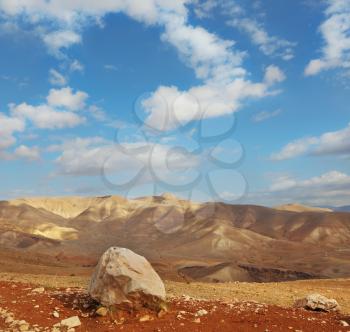 Magnificent transparent day in Judean desert. Huge boulders along highway, an unflawed sky

