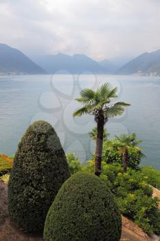 Lake Como in foggy a smoke. Magnificent park ashore - Villa Balbianella