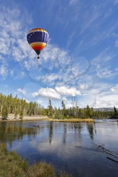 The picturesque multi-coloured balloon flies above cold northern lake