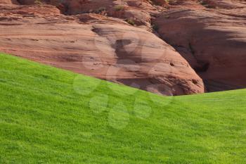 Hills from red sandstone and green grassy hills for a golf