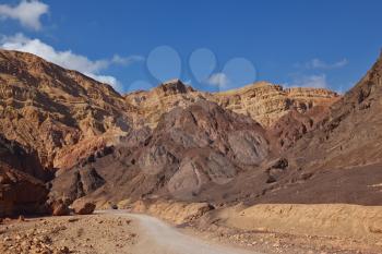 Ancient mountains in vicinities of Eilat in Israel. The car on tourist parking