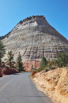 A bright sunny day in Zion National Park. The road passes close to the famous Checkerboard hill.
