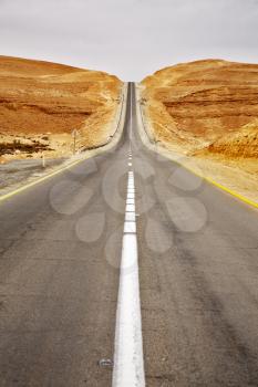 Asphalt highway in stone desert in clear spring day