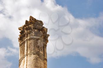  A high harmonous column in ancient port Caesaria on a background of the cloudy sky