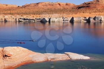 Antelope Canyon in the Navajo Reservation. Two boats with oars float near the water channel