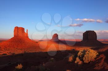 Sunset. Famous mittens of red sandstone on the background of blue sky and light clouds. 