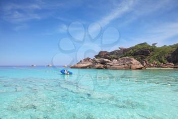 Exotic tropical Similan Islands. Clear azure ocean water. Moored in the bay inflatable boat