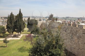 East Jerusalem from the walls surrounding the eternal city. The green lawns and a small park right next to the historic walls