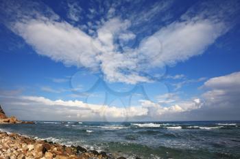 The Mediterranean coast. Azure waves and spectacular flying clouds
