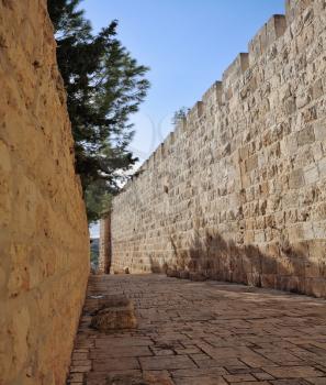 The narrow stone-paved street along the walls of Jerusalem