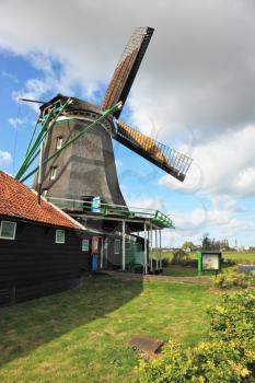 Pastoral landscape in the Netherlands. The windmill on the green hill