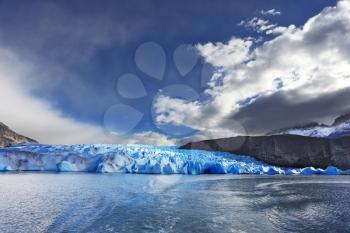 Chilean Patagonia. National Park Torres del Paine. Lake and Glacier Grey. The  sharp wind and the cold sun over blue ice