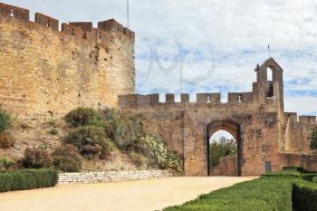The imposing medieval castle - the monastery of the Templars. Powerful protective wall around the monastery park