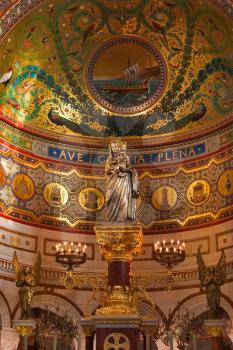  The gilt statue of the madonna with the baby in a cathedral in Marseilles