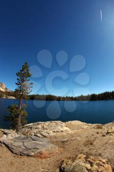 Early clear autumn morning. Picturesque transparent lake in mountains of national park Yosemite