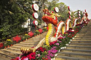 Traditionally decorated ladder in the Chinese park - a red dragon and bright flowers