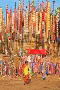 Multicolored flags and pennants adorn a special bamboo tower.  Thai New Year - Songkran
