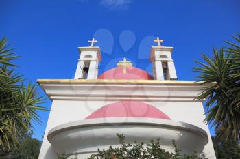 The white walls and pink domes Orthodox Church of the Twelve Apostles on the shore of Lake Kinneret.
