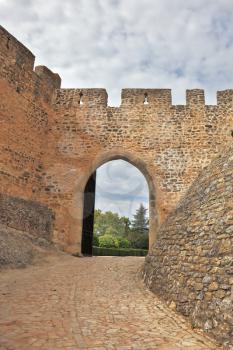 The imposing medieval castle - the monastery of the Templars. Powerful gear defensive walls and a way out of the park