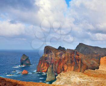  It is red and orange rocks coolly grow from foamy waves of the Atlantic Ocean. Easternmost tip of the island of Madeira