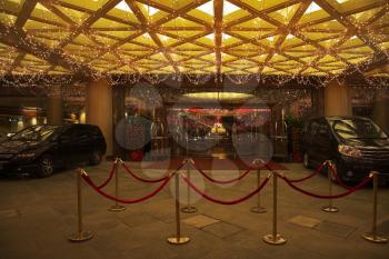 Festively decorated input in the Chinese hotel and cars near to it