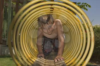  The boy with pleasure plays in the summer on a children's playground