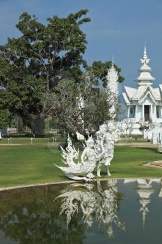 Fantastic snow-white palace. It is built in style of new Thai architecture. It is superb reflected in a pond with alive small fishes