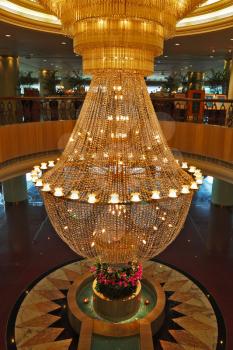 A huge magnificent crystal chandelier adorns the lobby expensive hotels