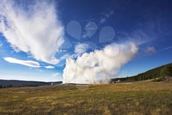 The well-known geyser in Yellowstone national park - Old Faithful. Eruption comes to an end