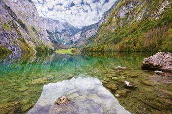 Fabulously beautiful lake Koenigssee in Austria. Mountainous lakeside reflected in the smooth water of the lake, like the wings of butterfly