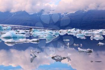 Icebergs and ice floes in the blue lagoon Ice Jokulsarlon. South-east Iceland in July