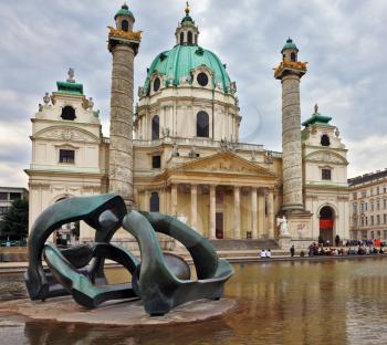 VIENNA, AUSTRIA - SEPTEMBER 26, 2013: The Church of St. Charles Borromeo. On the square in front of the church in big pond sculpture art nouveau