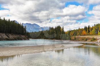 Shining silvery surface of the lake. Early autumn in the Rocky Mountains of Canada.