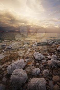 Coast of the Dead Sea in Israel in a spring thunder-storm. The coastal stones covered by salty adjournment