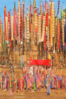 Colorful flags and pennants adorn a special bamboo tower.  Thai New Year - Songkran
