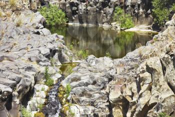 Small pond in a granite channel of a mountain stream