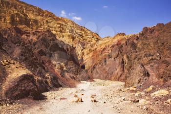 Road among geological layers in stone desert in the south