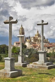 Glade with a chapel and memorable crosses on a background of a Gothic cathedral in Segovia 