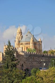 The Church  in Jerusalem. Battlements of Jerusalem surrounded by majestic building. The morning sun illuminates the dome