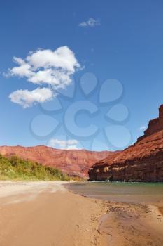 Wild River Colorado. The sandy beach and the steep slope of red sandstone