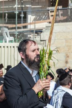 JERUSALEM, ISRAEL - OCTOBER 12, 2014:  Morning autumn Sukkot. The area in front of Western Wall of Temple filled with people. Pilgrims brought the prayer ritual and four plants