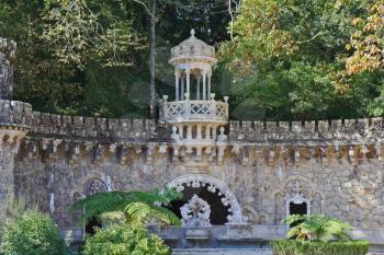Old park. Art pavilions, grottoes and jagged walls of the Moorish-style illuminated by the sun
