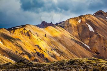 Multicolored rhyolite mountains scenic highlights the July sun. Travel to Iceland in the summer