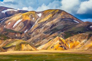 National park Landmannalaugar. Multi-color rhyolitic mountains are lit with the July sun. Travel to Iceland in the summer