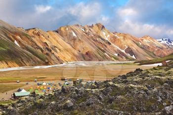 Rhyolite mountains smoldering underground heat. In the valley Landmannleugar is camping. Iceland in July