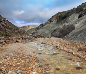 National Park Landmannalaugar in Iceland. Creek in the gorge between the mountains of black volcanic ash