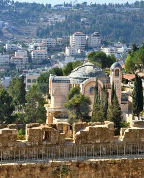  The morning sun illuminates the dome. The Church  in Jerusalem. Battlements of Jerusalem surrounded by majestic building.  On the wall is fenced path for walks