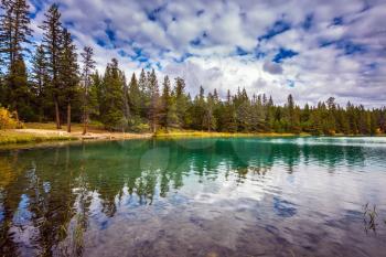 The picturesque round lake with clear water. Lake Annette, Canadian Rocky Mountains