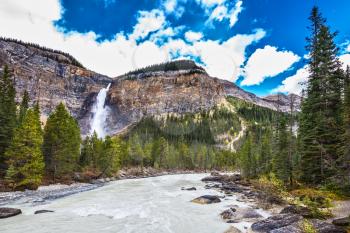 Autumn day in Yoho National Park in the Rocky Mountains of Canada. The tremendous falls Takakkaw formed by thawing of glacier Daly